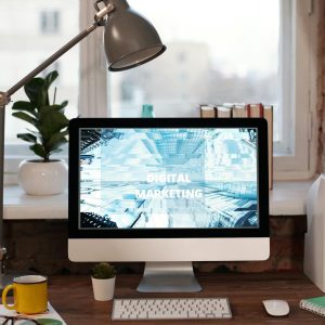Contemporary home office desk with digital marketing screen, perfect for remote work inspiration.